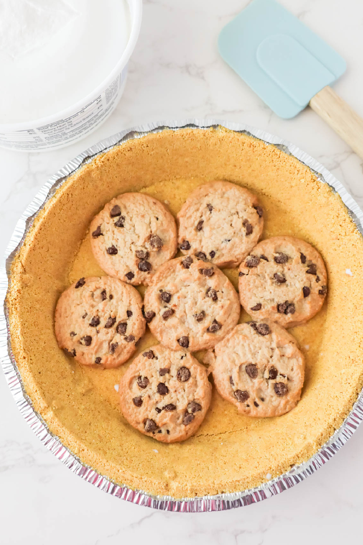 Chocolate chip cookies arranged on a pie crust