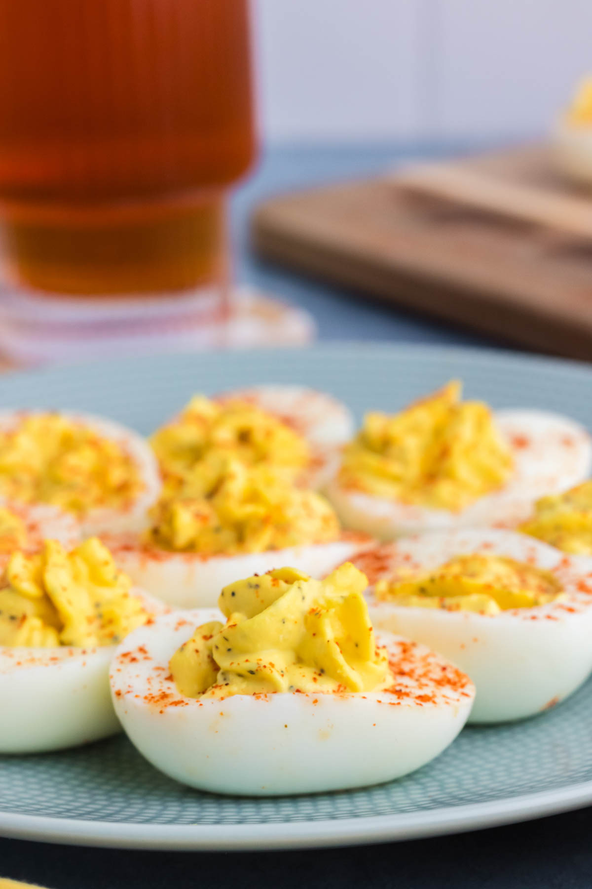 A plate of deviled eggs sprinkled with paprika