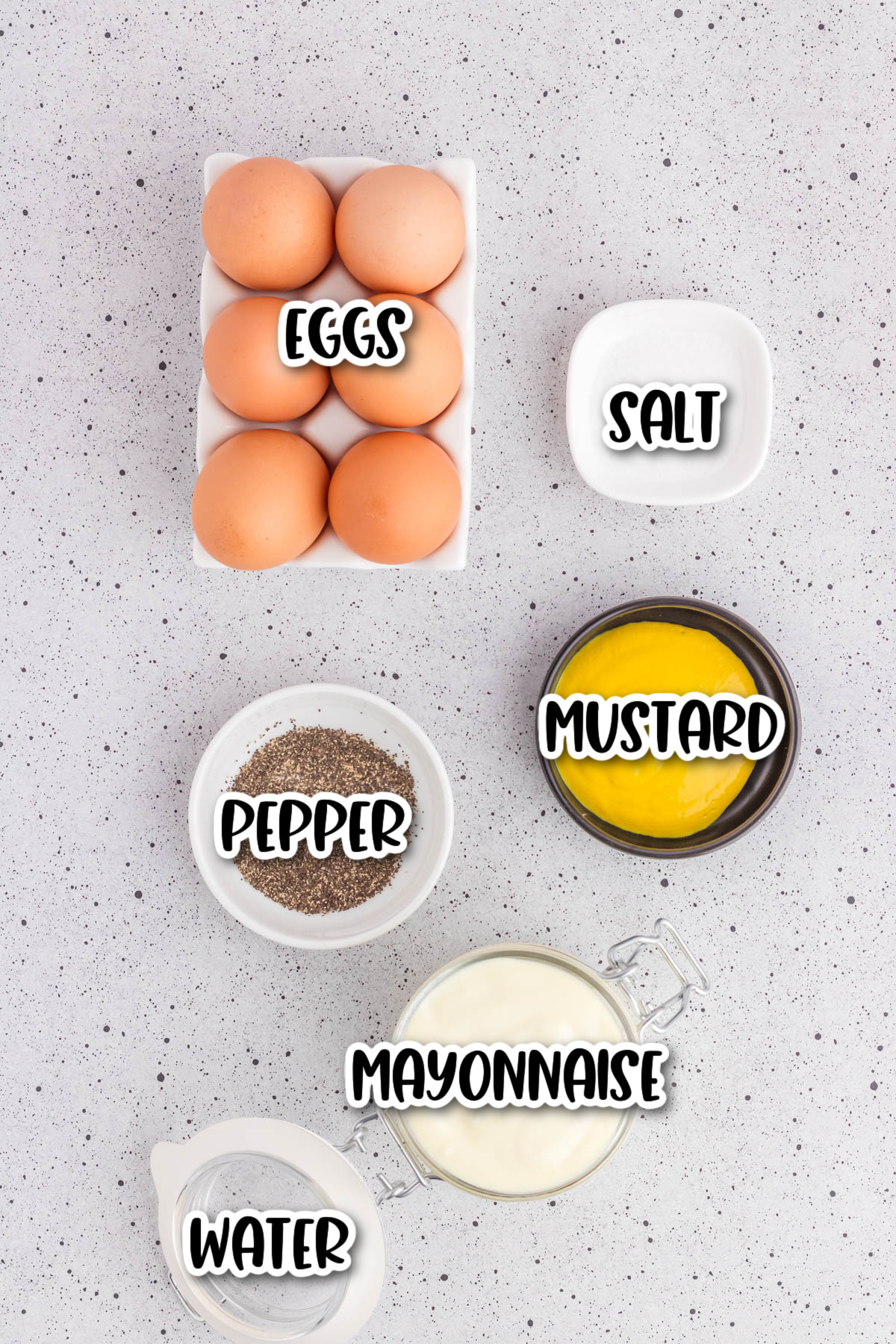 Ingredients for deviled eggs displayed on a countertop, labeled eggs, salt, pepper, mustard, mayonnaise, and water.