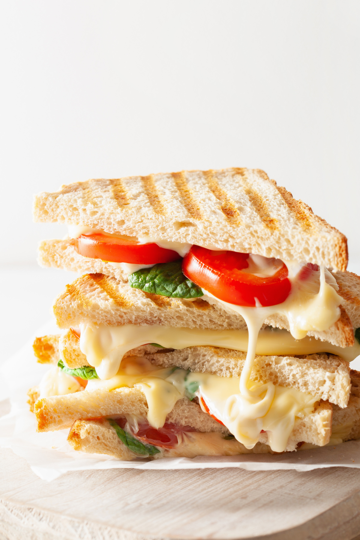 A grilled cheese sandwich with tomato and lettuce.