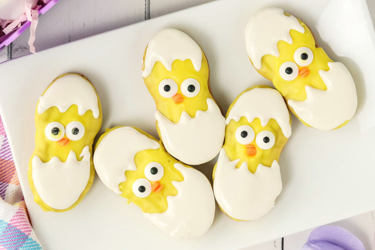Nutter Butter Easter chick cookies on a white plate.