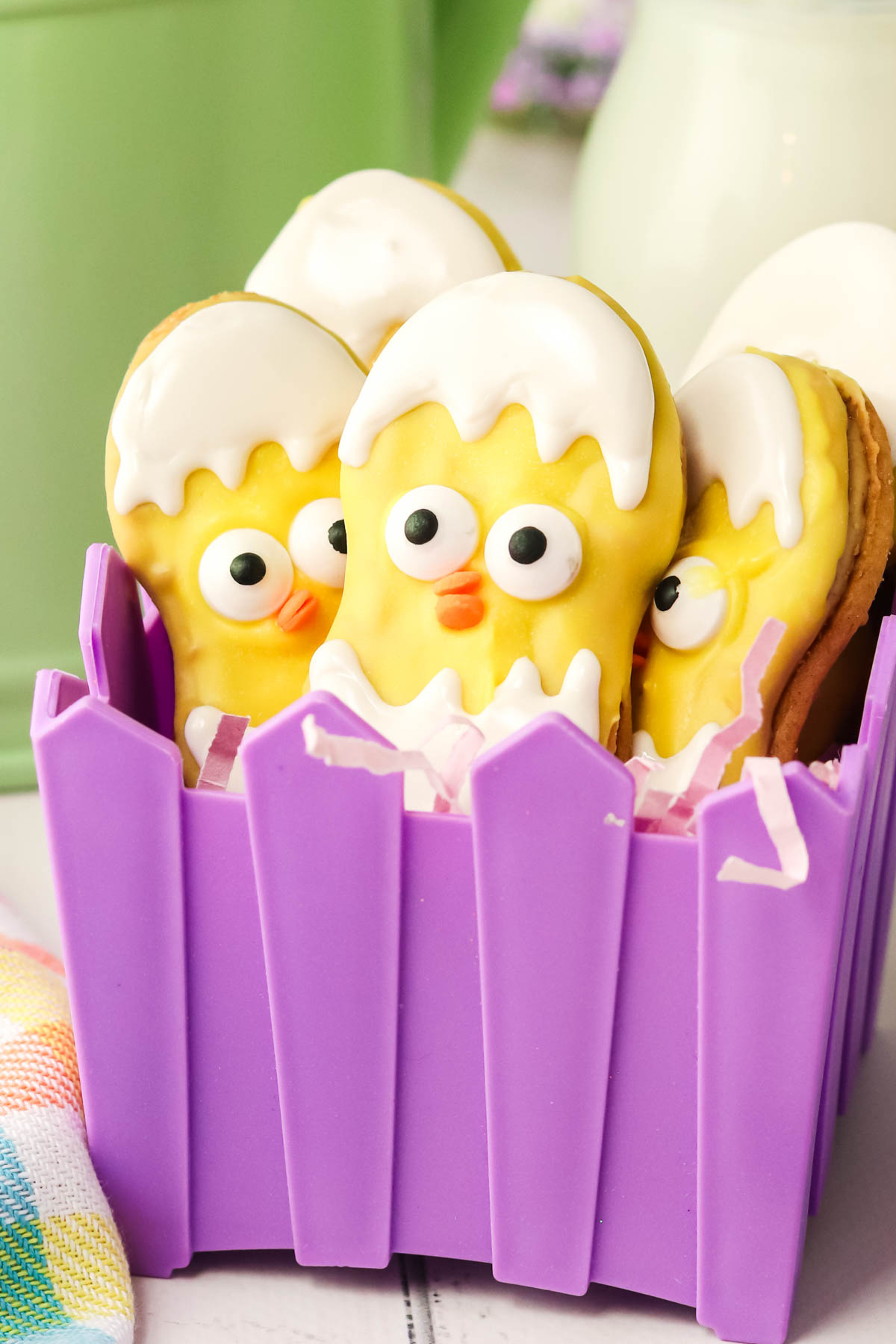 Easter chick cookies in a purple basket.