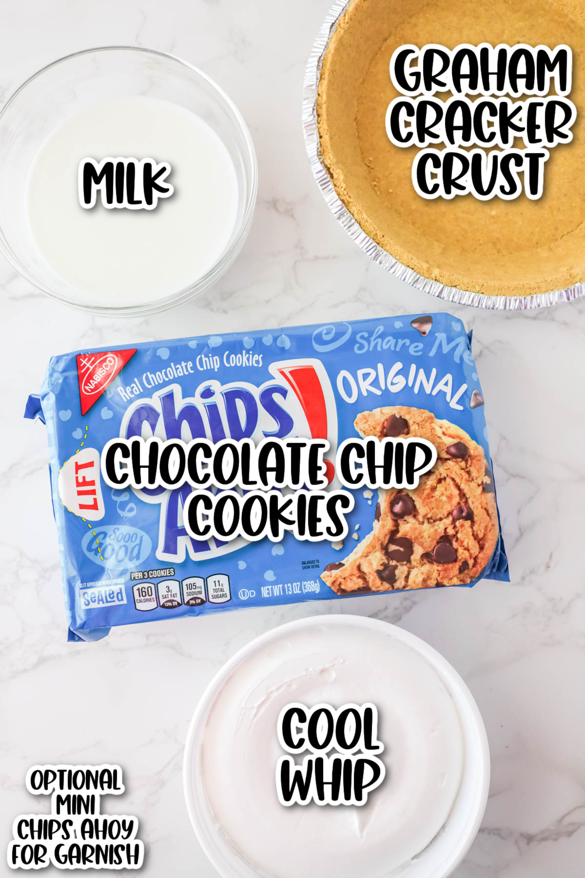 Ingredients for a dessert displayed on a countertop, including milk, a graham cracker crust, chocolate chip cookies, and cool whip, labeled accordingly.