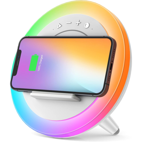 A smartphone rests on a circular wireless charging stand with a colorful LED light ring and touch control buttons. The phone screen displays a full battery icon.