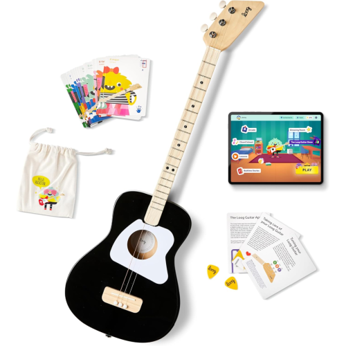 A black and white toy guitar, illustrated cards, a cloth bag, yellow guitar picks, instructional sheets, and a tablet displaying a children's guitar app are arranged on a white background.