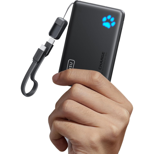 A hand holding a black portable power bank with a glowing blue paw print symbol and a short USB charging cable attached.