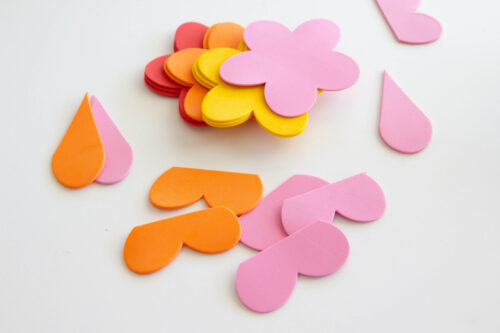 Assorted foam cutouts in the shapes of flower petals arranged on a white surface.