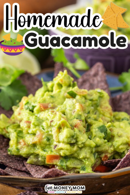 A bowl of homemade guacamole served with blue corn tortilla chips, garnished with cilantro and lime in the background.