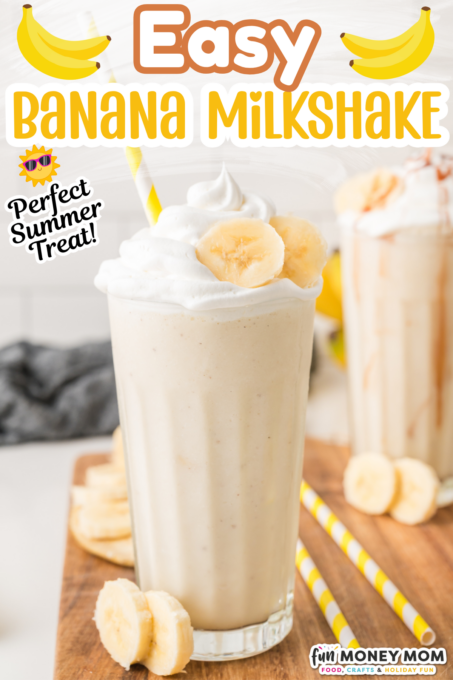 A glass of banana milkshake topped with whipped cream and banana slices, with a yellow striped straw and more banana slices on the wooden board.