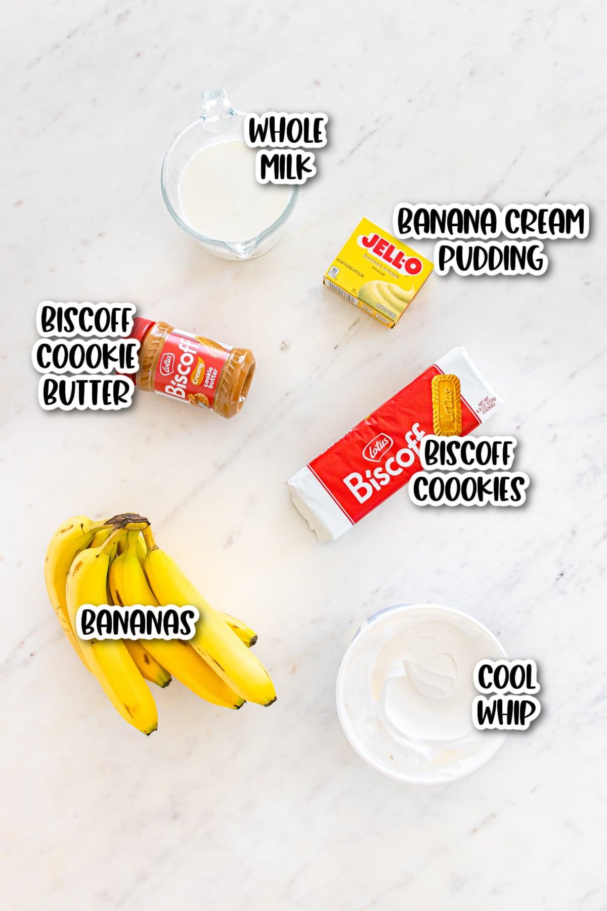 Ingredients for a banana cream pudding dessert: whole milk, Jell-O banana cream pudding, Biscoff cookie butter, Biscoff cookies, bananas, and Cool Whip.