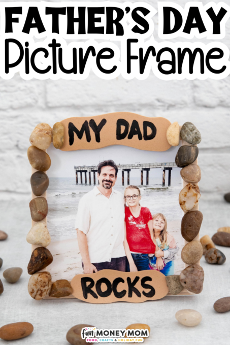 A photo frame decorated with rocks displays a family photo and the words "MY DAD ROCKS." Above, text reads "FATHER'S DAY Picture Frame." Stones are scattered around the frame.