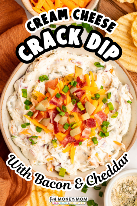 A bowl of creamy dip topped with bacon, cheddar cheese, and green onions, surrounded by chips and a small bowl of seasoning. Text reads: Cream Cheese Crack Dip With Bacon & Cheddar.