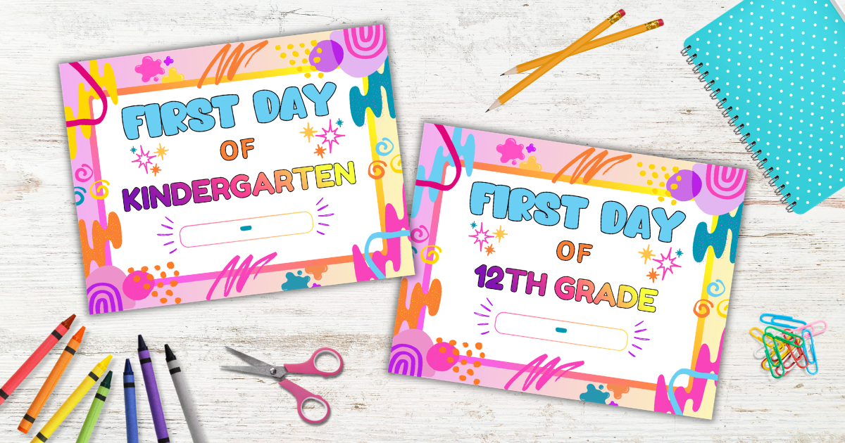 Two colorful “First Day” signs for kindergarten and 12th grade on a white table, surrounded by school supplies like crayons, scissors, pencils, and a blue notebook.