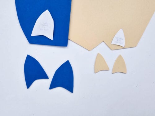 Two blue and two beige craft foam shapes, each with matching paper templates, are arranged on a white background.