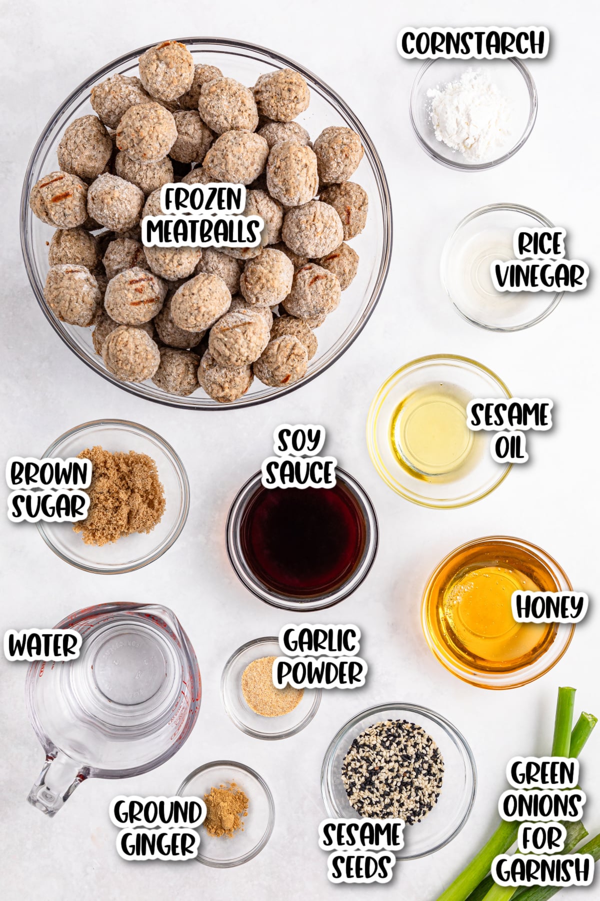 Ingredients for a meatball recipe, including frozen meatballs, brown sugar, soy sauce, water, cornstarch, rice vinegar, sesame oil, honey, garlic powder, ground ginger, sesame seeds, and green onions.