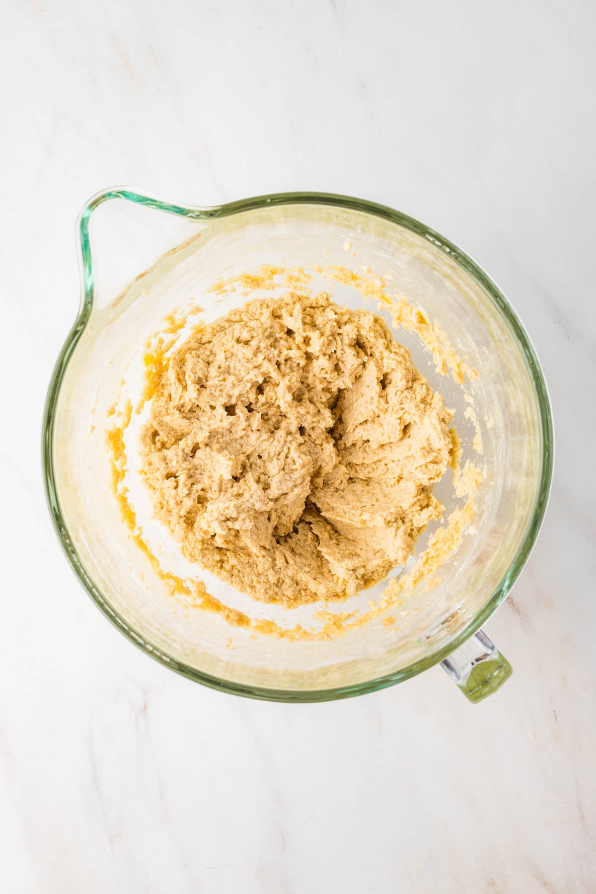 Cookie dough in a glass mixing bowl.