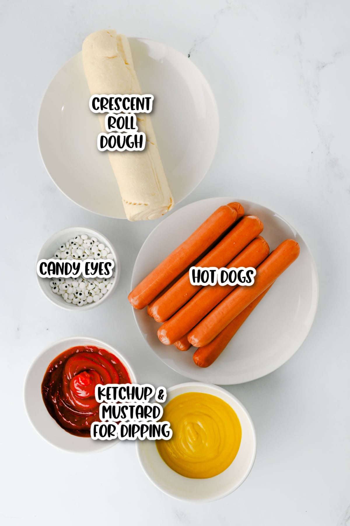 Ingredients for making mummy hot dogs: a roll of crescent dough, hot dogs, candy eyes, ketchup, and mustard.